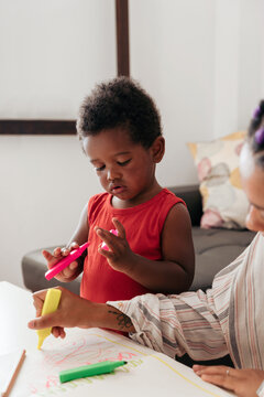 Mother and son drawing at home
