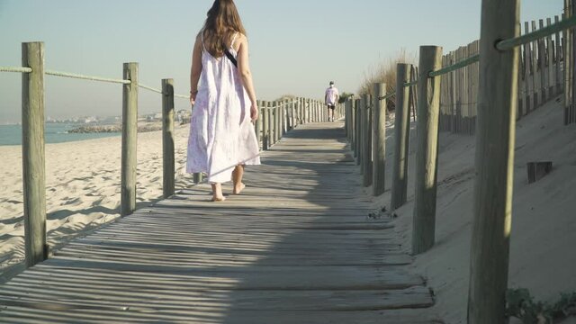 Walking on a wooden path at the atlantic ocean