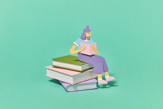 Stack of books with reading papercraft girl.