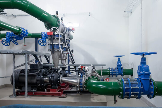 Water pump station and pipeline with tanks in an industrial room to supply high pressure water for firefight tasks. Sprinkler pipes and control system to provide drink water to people in building
