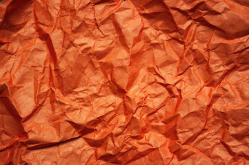 Crumpled orange textured paper background