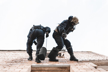 Two commandos train at the base. Climbers. SWAT, police, counterterrorism concept.