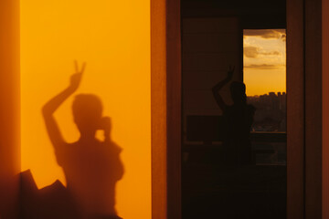 Young woman sunlight shadow on the wall.