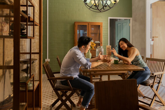 Couple playing Tumbling Towers