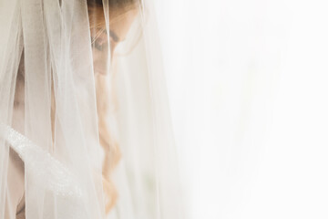 the bride closed her eyes and tulle in the foreground. profile.