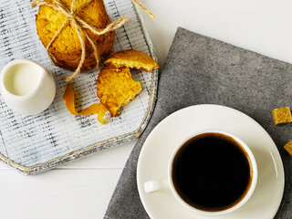 coffee with milk and orange cookies