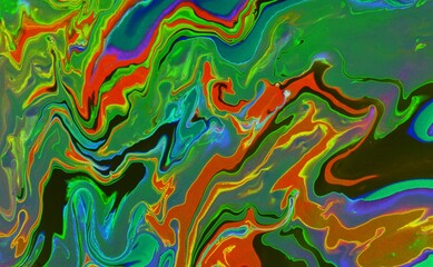 Abstract multi-colored marble background. Acrylic paint flows freely and creates an interesting...