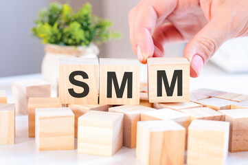 smm concept with wooden blocks on table, business concept