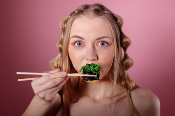 Woman eats sushi with chuka bamboo sticks