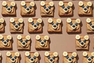 Cute bear face toasts with peanut butter, banana and blueberries