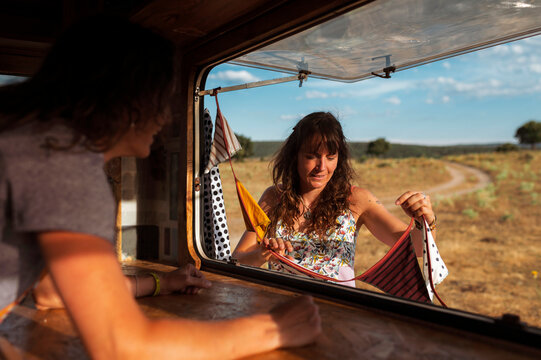 Woman decorating van with flags
