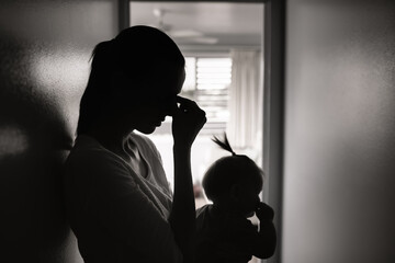 Tired mother taking care of child
