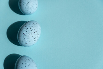 Easter blue eggs on a blue background, Easter card with copy space for text