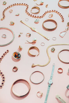 Jewellery,diamonds, ruby, gold, silver etc/ on pink background