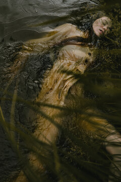 woman with closed eyes lies in water