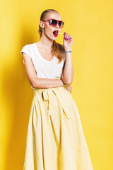 hot woman in long yellow skirt with red lollipop