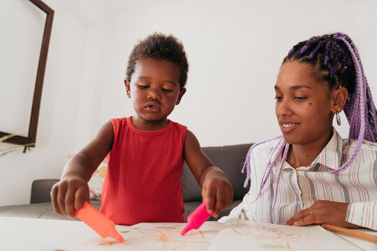 Mother and son drawing at home