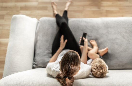 Mother And Child At Home Watching Tv