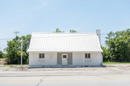 The front of a white building along a road