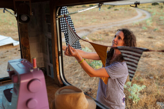 Woman decorating van with flags