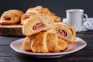 Croissant cut in half and stuffed with ham and cheese