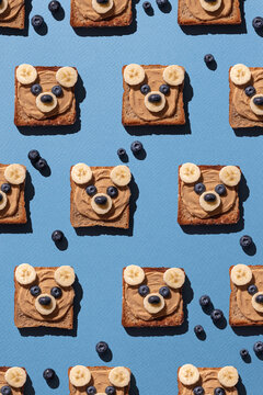 Cute bear face toasts with peanut butter, banana and blueberries