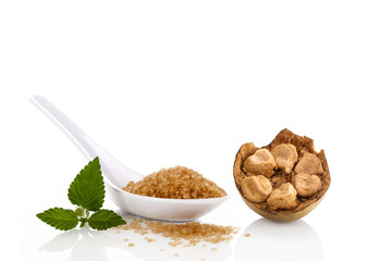 Heap of brown cane crystallized sugar and monk fruit.