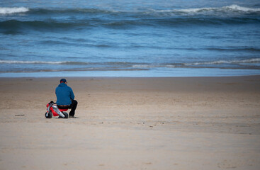 sitting on the beach looking at the sea