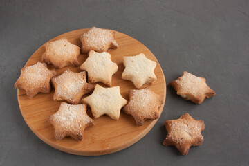 Delicious homemade cookies in the shape of stars sprinkled with sugar. Laid out on a kitchen board...