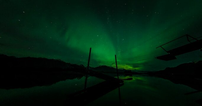 aurora borealis over river with broken dock