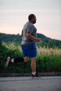 Plump Man Jogging Outside