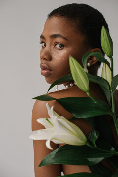 Beauty portrait of woman with lily flowers