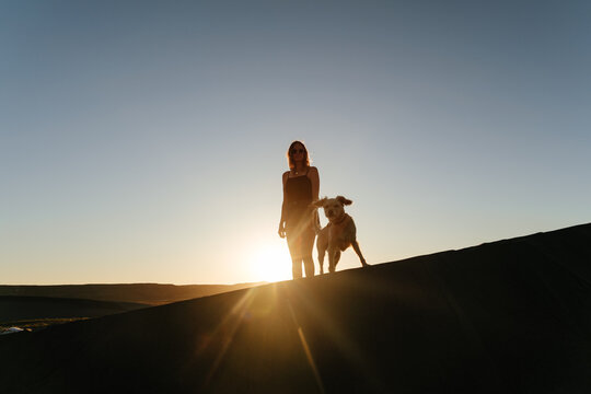 Woman And Dog Sunset