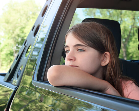 Girl Looking Out Car Window in Summer