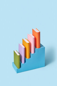 Books handmade from paper on a staircase.