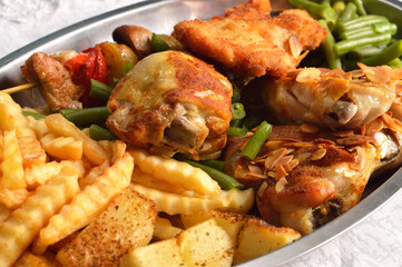 Various chicken dishes. Chicken with almonds. BBQ Chicken. Fried Chicken leg  with french fries and roasted potatoes with green beans .