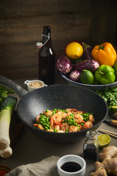Tasty shrimps in wok with peas
