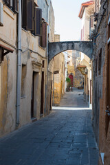 Fototapeta na wymiar Picturesque Rhodes old town street with an arch and no people. Dodecanese, Greece.