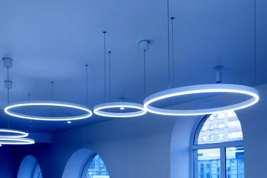 Ceiling With Round Modern LED Lamps. Suspended Fluorescent Lights Under The Ceiling. Careful Energy Consumption, Energy Saving Concept