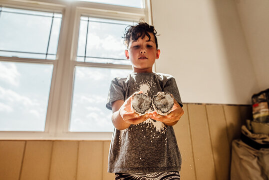 Child holding crystal geodes.