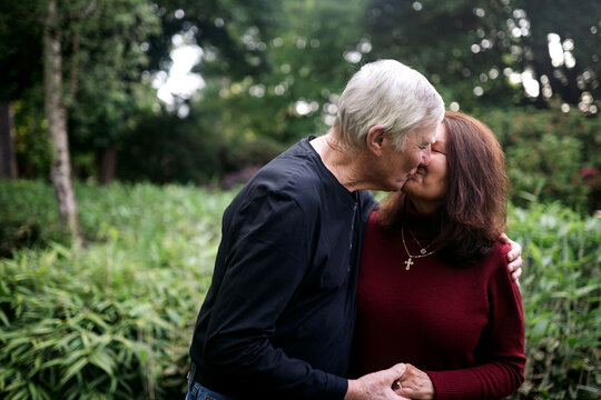 Affectionate older couple spending time together in a park.