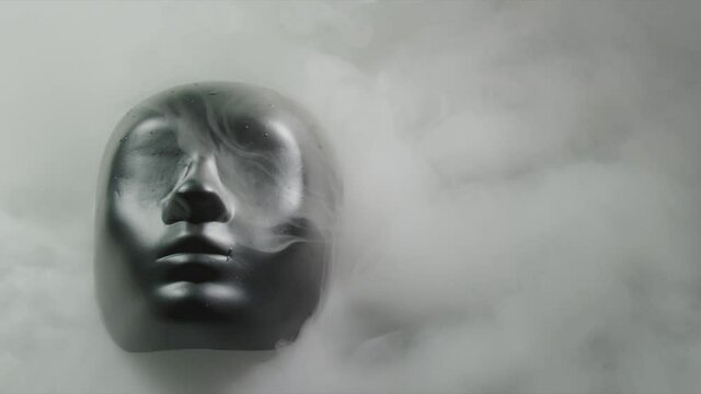 Black face mask on curling fog, slow motion shot