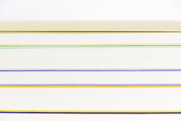 Background, front view of a stack of books. Colored lines and white stripes