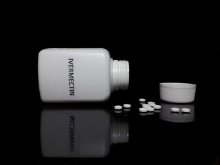 Ivermectin pills on black background, covid 19 treatment