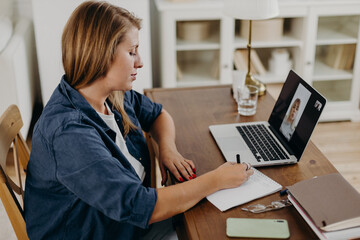 Online psychologist listening to patient and making notes