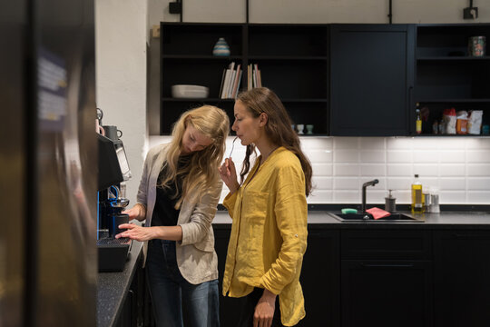 Colleagues Making Cofee In The Office