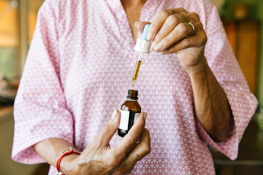 Senior Citizen With Arthrits Using CBD Cannabis Oil