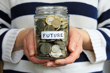 A Glass Jar labelled Future Full Of Money. Holding Your Future In Your Hands Concept.