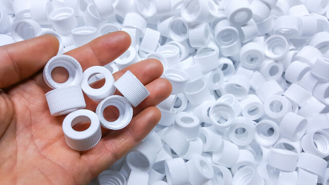 White Medical plastic bottle caps. Made from injection molding machine, of the manufacturing and assembly department, In the plastics industry