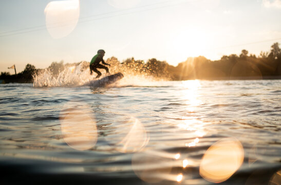 Young Male Surfer Surfing On A Wakeboard